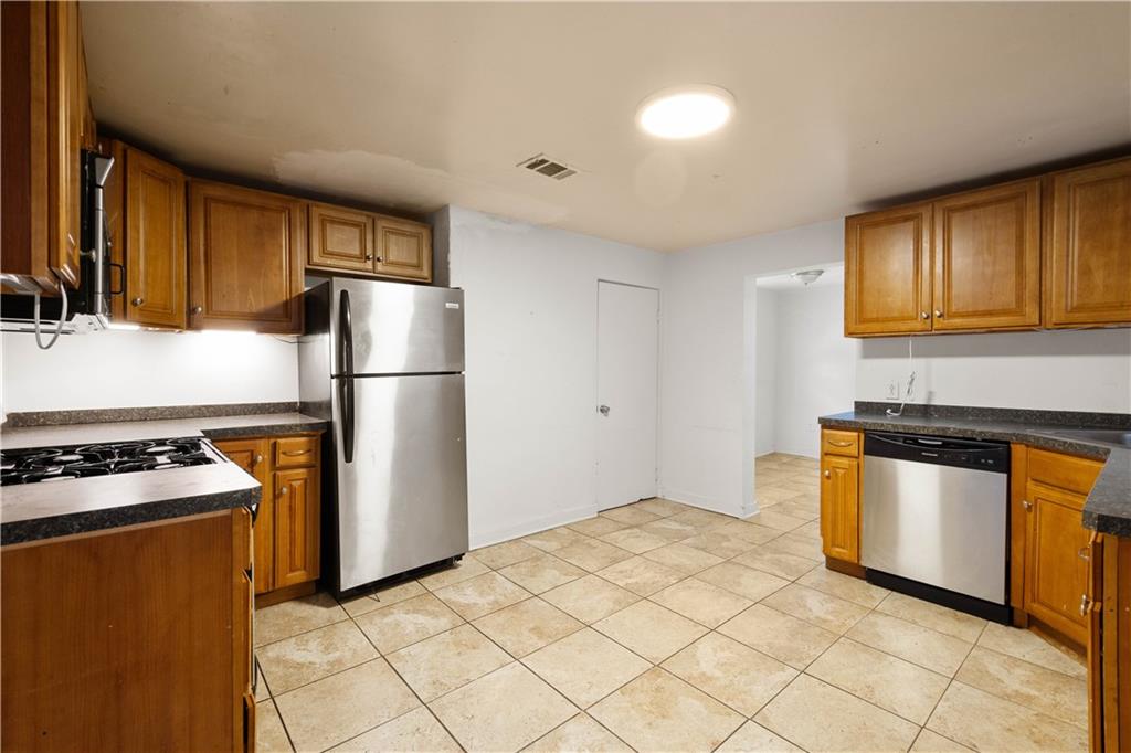 108 Pius Street Pittsburgh, PA 15203 - Photo 16 of 36 a kitchen with stainless steel appliances granite countertop a refrigerator a stove a sink dishwasher and a refrigerator