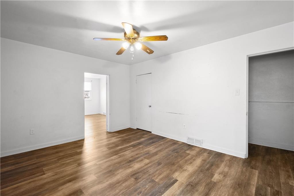 108 Pius Street Pittsburgh, PA 15203 - Photo 21 of 36 an empty room with wooden floor and windows