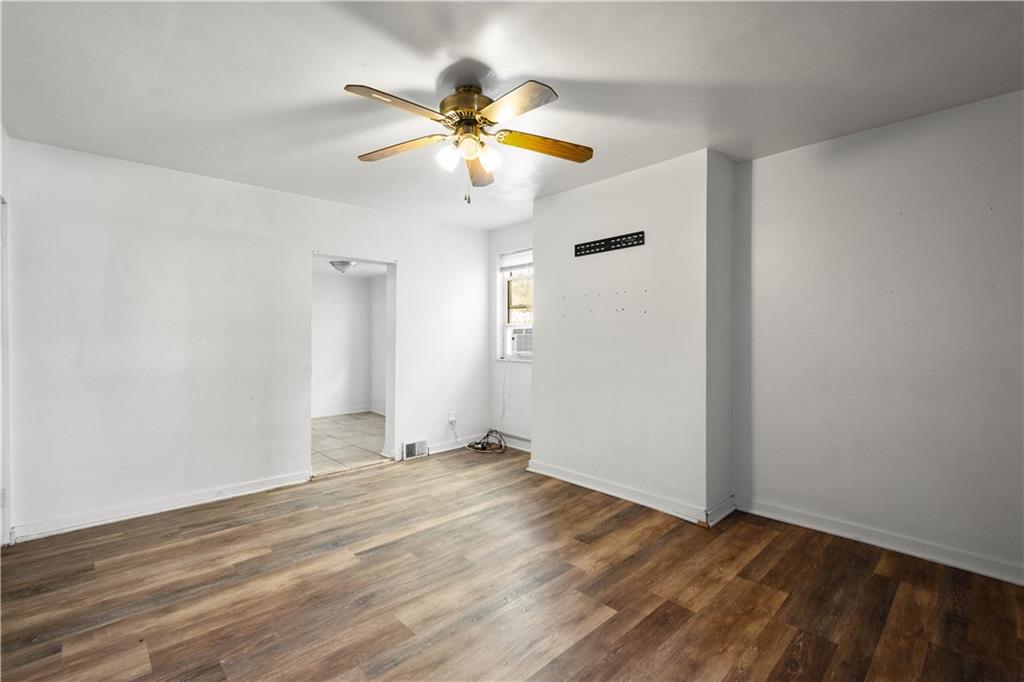 108 Pius Street Pittsburgh, PA 15203 - Photo 22 of 36 an empty room with wooden floor fan and windows