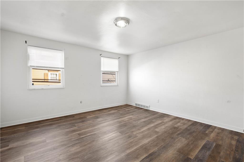 108 Pius Street Pittsburgh, PA 15203 - Photo 23 of 36 an empty room with wooden floor and windows