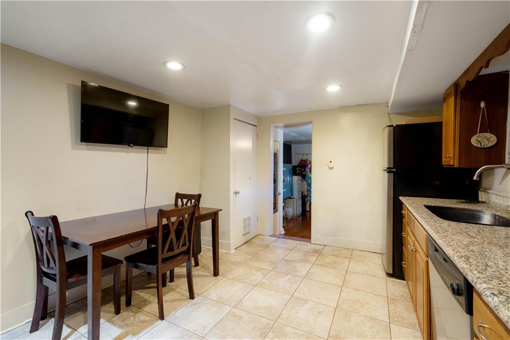 108 Pius Street Pittsburgh, PA 15203 - Photo 8 of 36 a kitchen with stainless steel appliances granite countertop a sink a microwave and a refrigerator