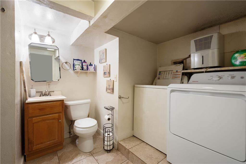 108 Pius Street Pittsburgh, PA 15203 - Photo 10 of 36 a bathroom with a toilet a sink and a mirror