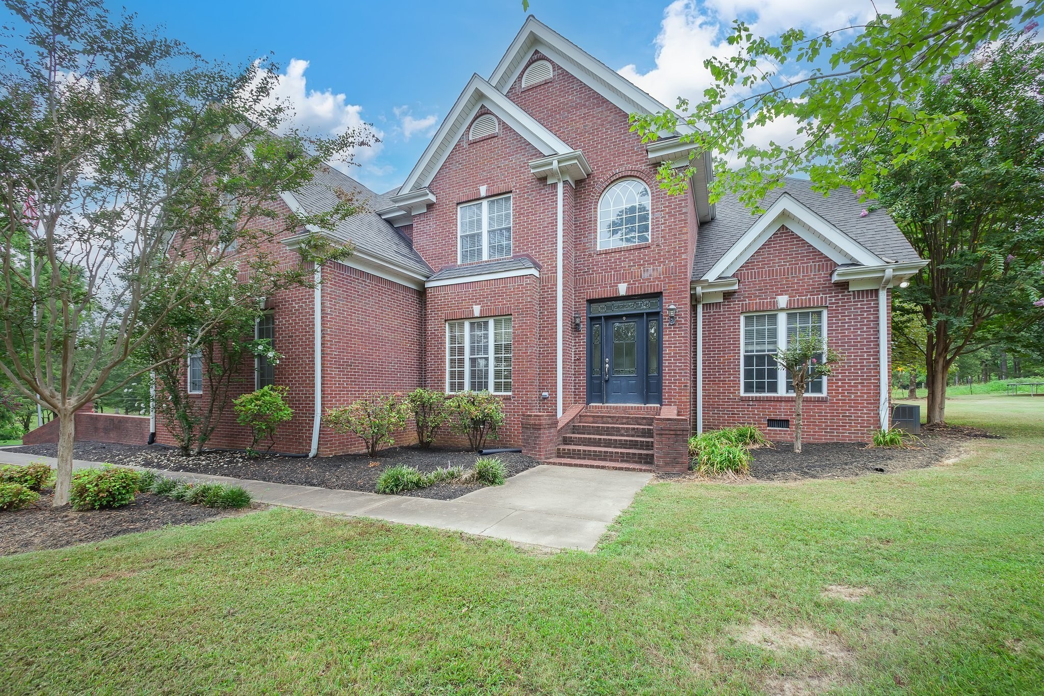 a front view of a house with garden