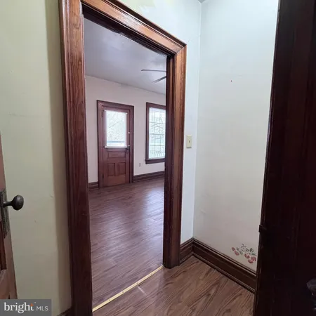 a view of a hallway with wooden floor