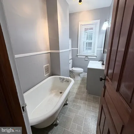 a bathroom with a tub and sink