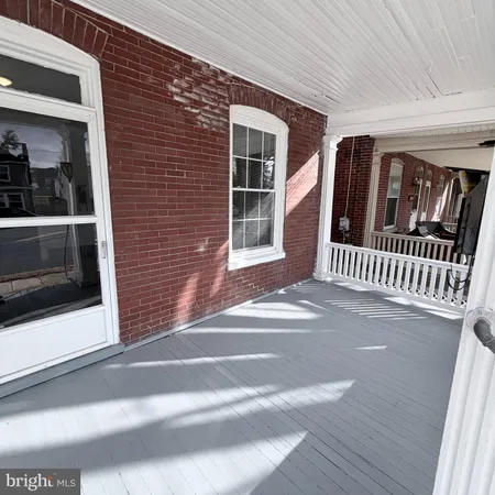 a view of a brick house with a large window