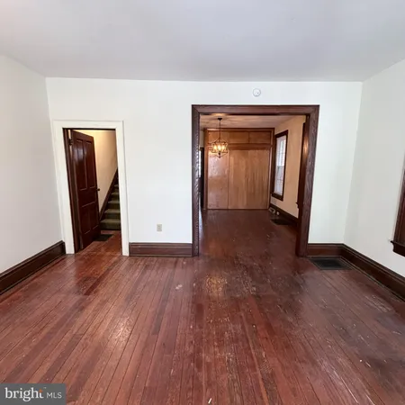 an empty room with wooden floor and closet