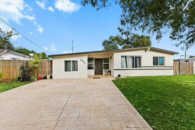 a front view of a house with yard and green space
