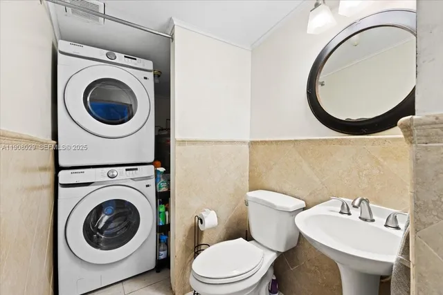 a bathroom with a toilet mirror sink and vanity