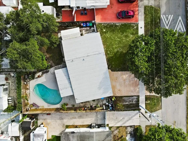 an aerial view of a house with outdoor space and a garden