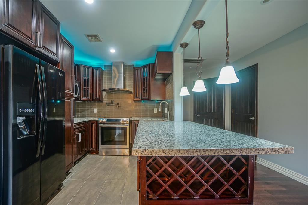 a kitchen with stainless steel appliances granite countertop a kitchen island a cabinets and wooden floor