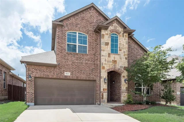 a front view of a house with yard