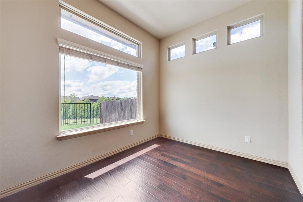 9641 Calaveras Road Fort Worth, TX 76177 - Photo 10 of 24 a view of an empty room with wooden floor and a window