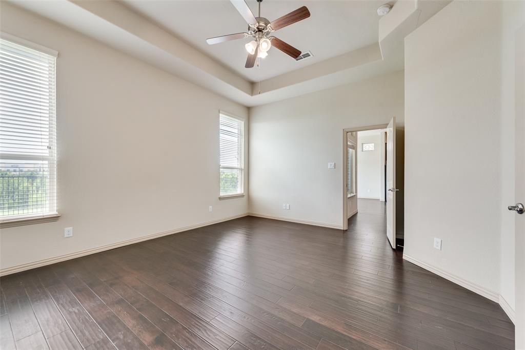 9641 Calaveras Road Fort Worth, TX 76177 - Photo 13 of 24 an empty room with wooden floor chandelier fan and windows