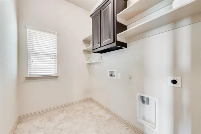 an empty room with wooden floor chandelier fan and windows