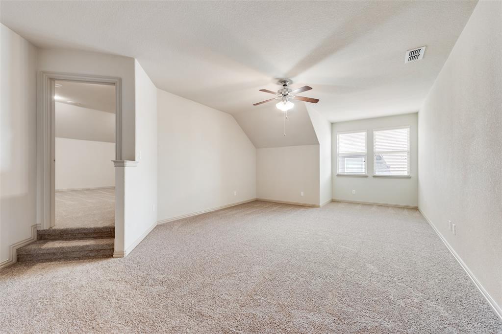 9641 Calaveras Road Fort Worth, TX 76177 - Photo 17 of 24 an empty room with chandelier fan and windows