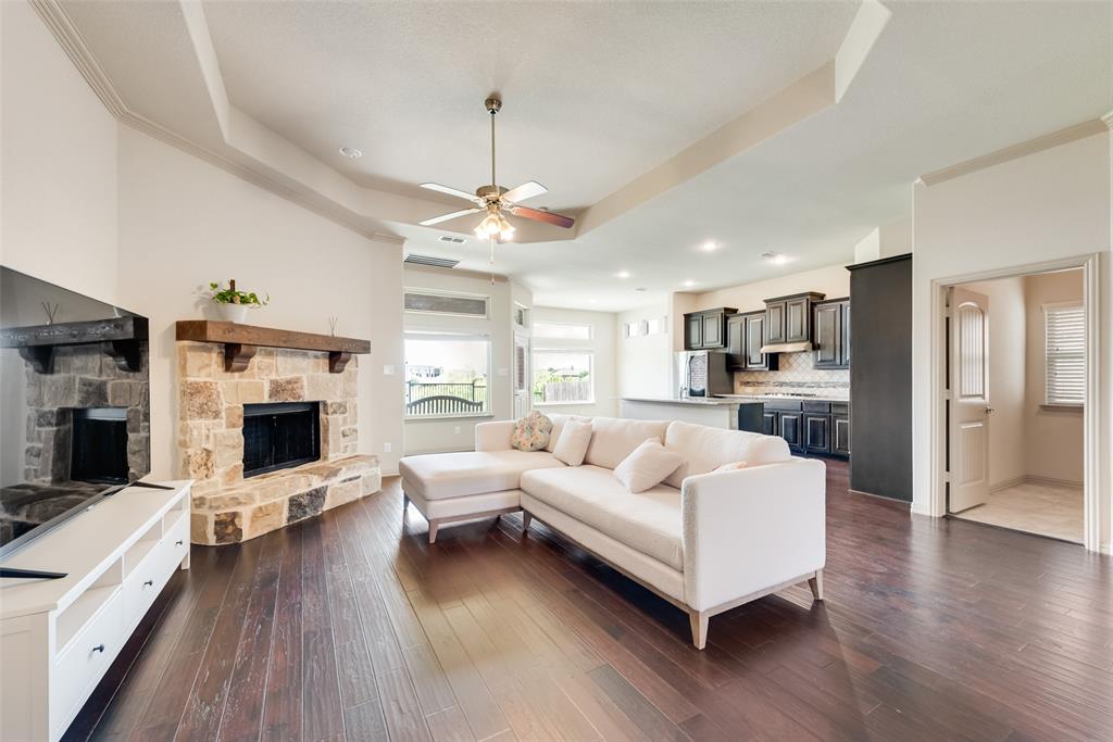 9641 Calaveras Road Fort Worth, TX 76177 - Photo 4 of 24 a living room with furniture wooden floor and a fireplace