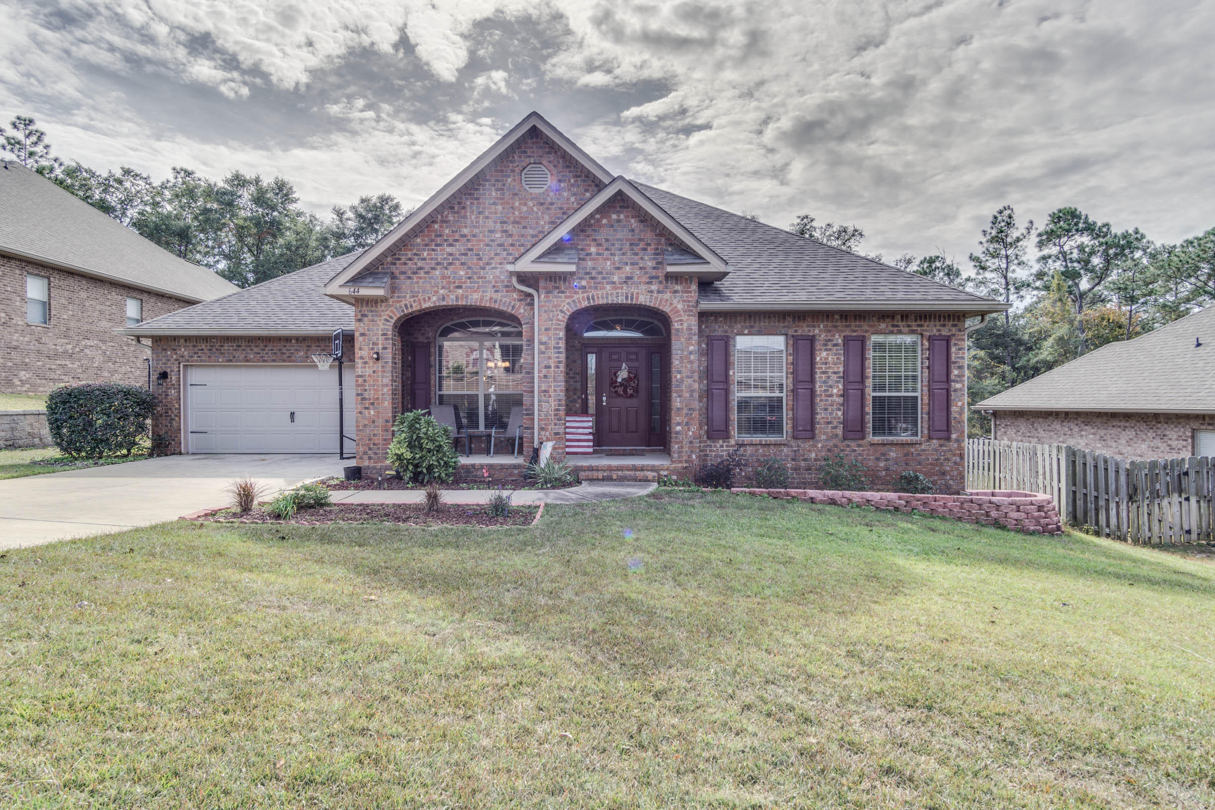 644 Red Fern Road Crestview, FL 32536 - Photo 1 of 46 a front view of a house with a yard and garage
