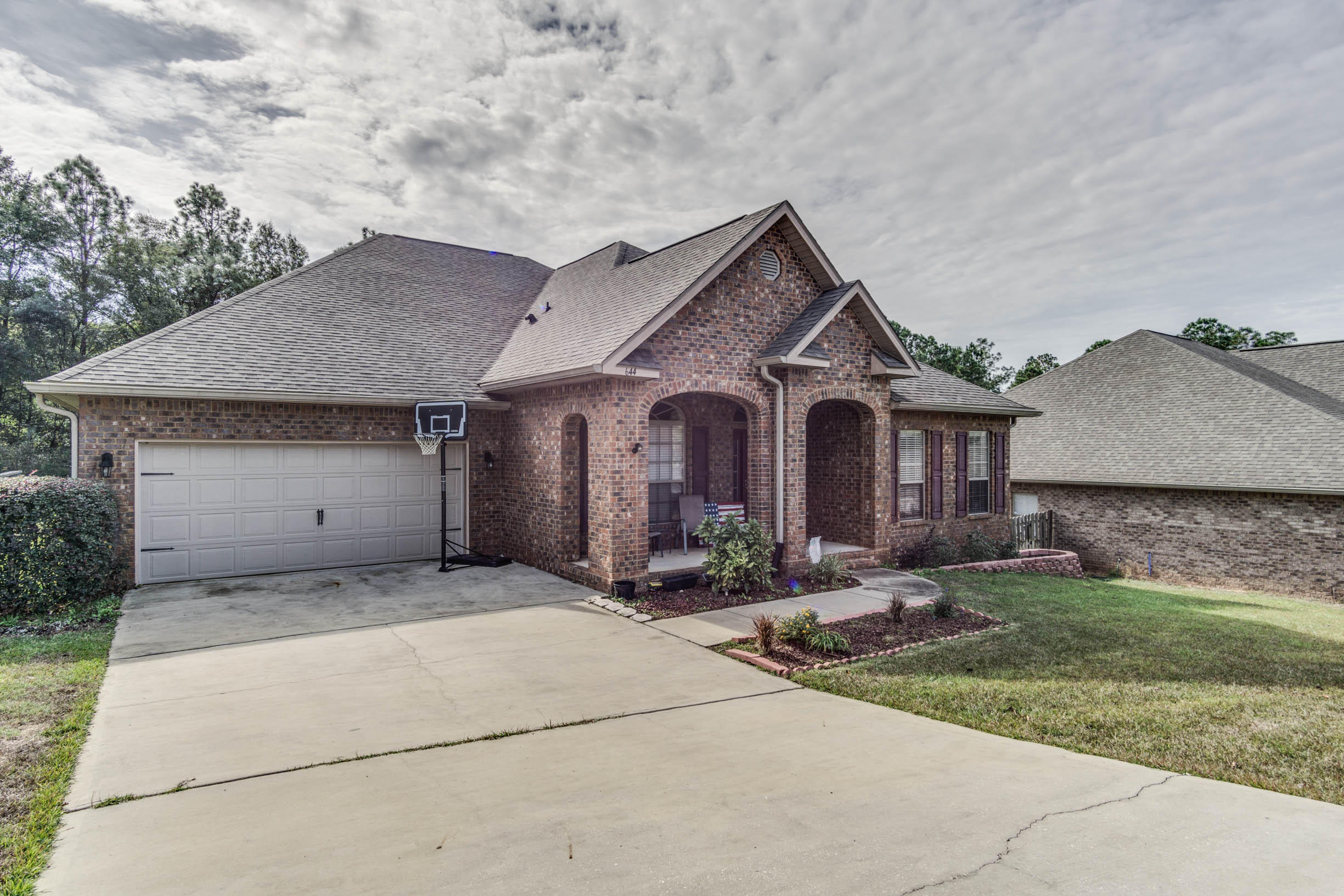 644 Red Fern Road Crestview, FL 32536 - Photo 2 of 46 a front view of a house with yard and tress