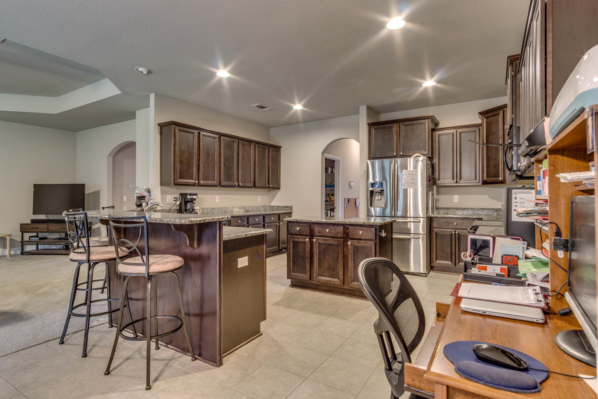 644 Red Fern Road Crestview, FL 32536 - Photo 22 of 46 a kitchen with stainless steel appliances kitchen island granite countertop a table chairs in it and wooden floors