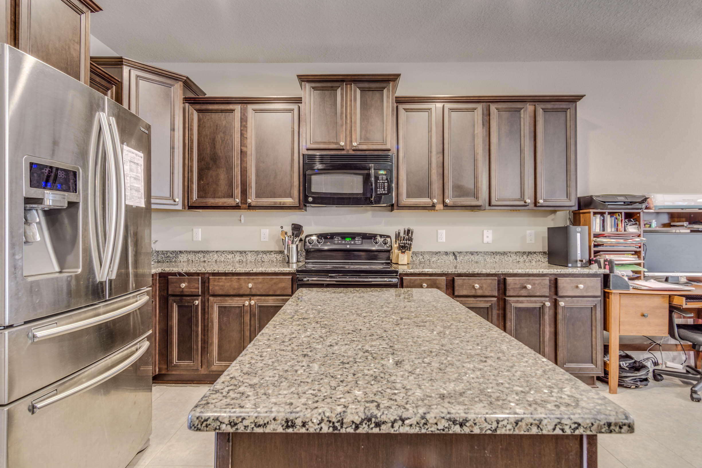 644 Red Fern Road Crestview, FL 32536 - Photo 24 of 46 a kitchen with stainless steel appliances granite countertop a stove top oven a sink and a refrigerator