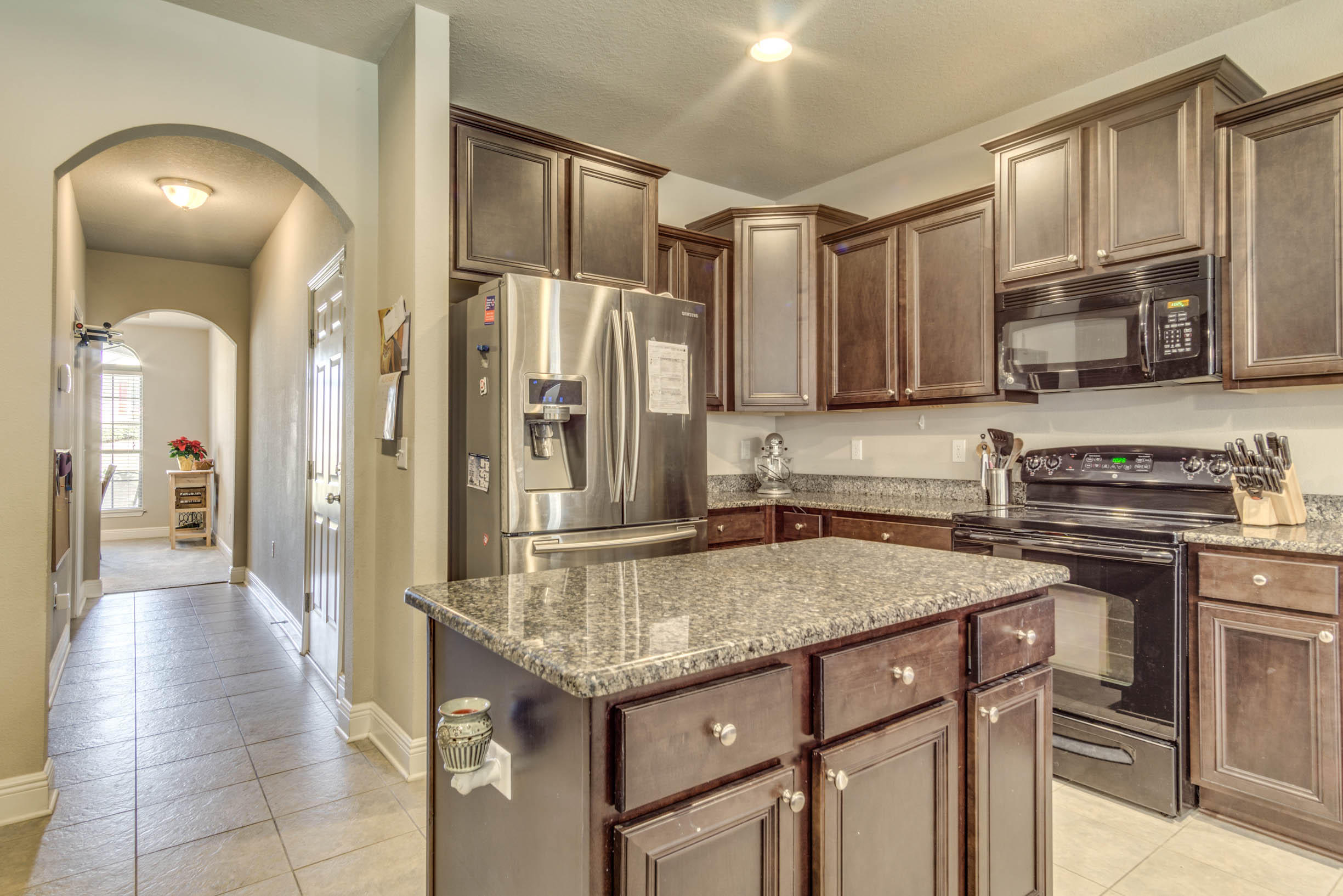 644 Red Fern Road Crestview, FL 32536 - Photo 25 of 46 a kitchen with stainless steel appliances granite countertop a sink stove and refrigerator