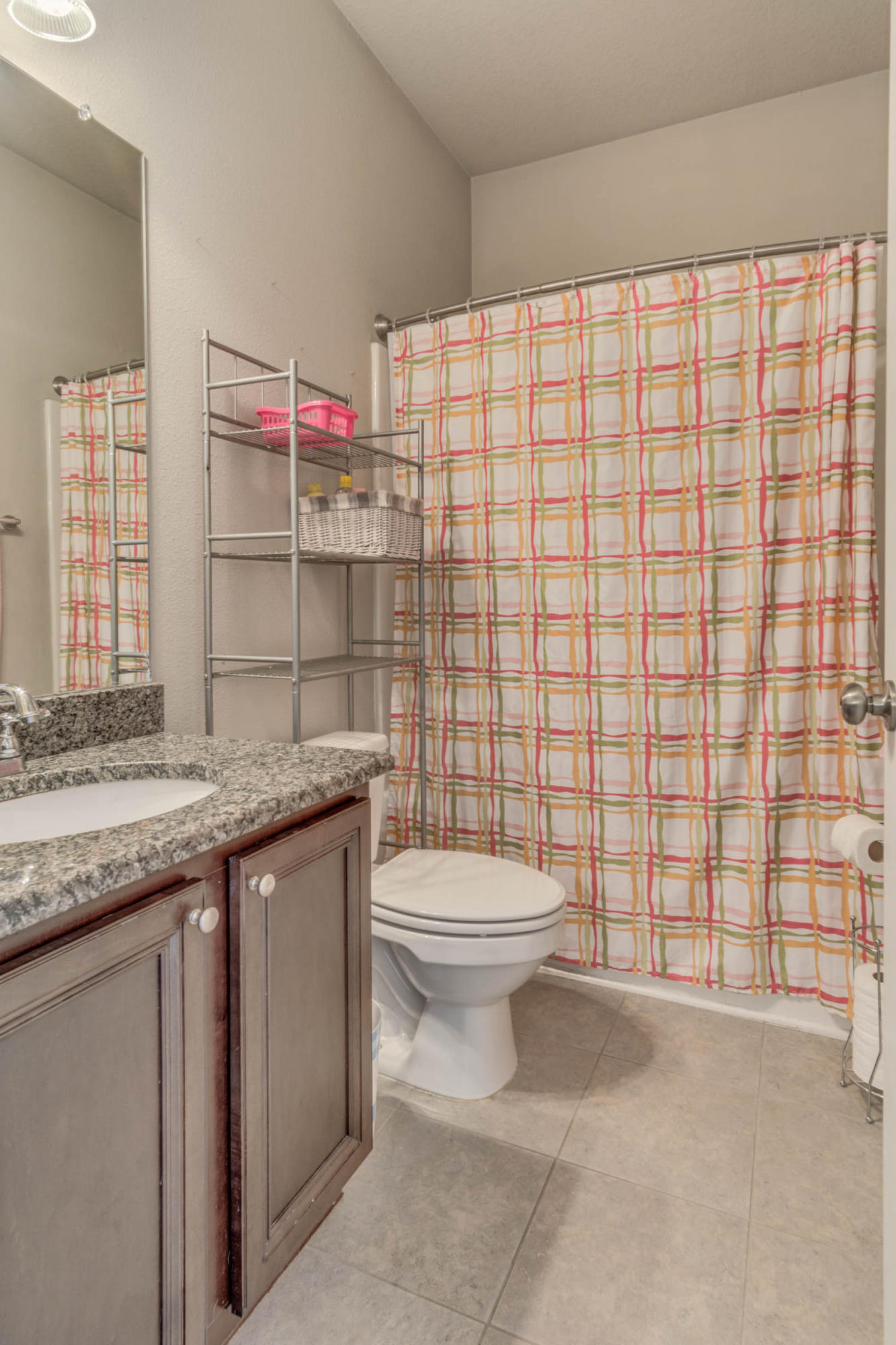 644 Red Fern Road Crestview, FL 32536 - Photo 35 of 46 a bathroom with a granite countertop toilet sink and shower curtain