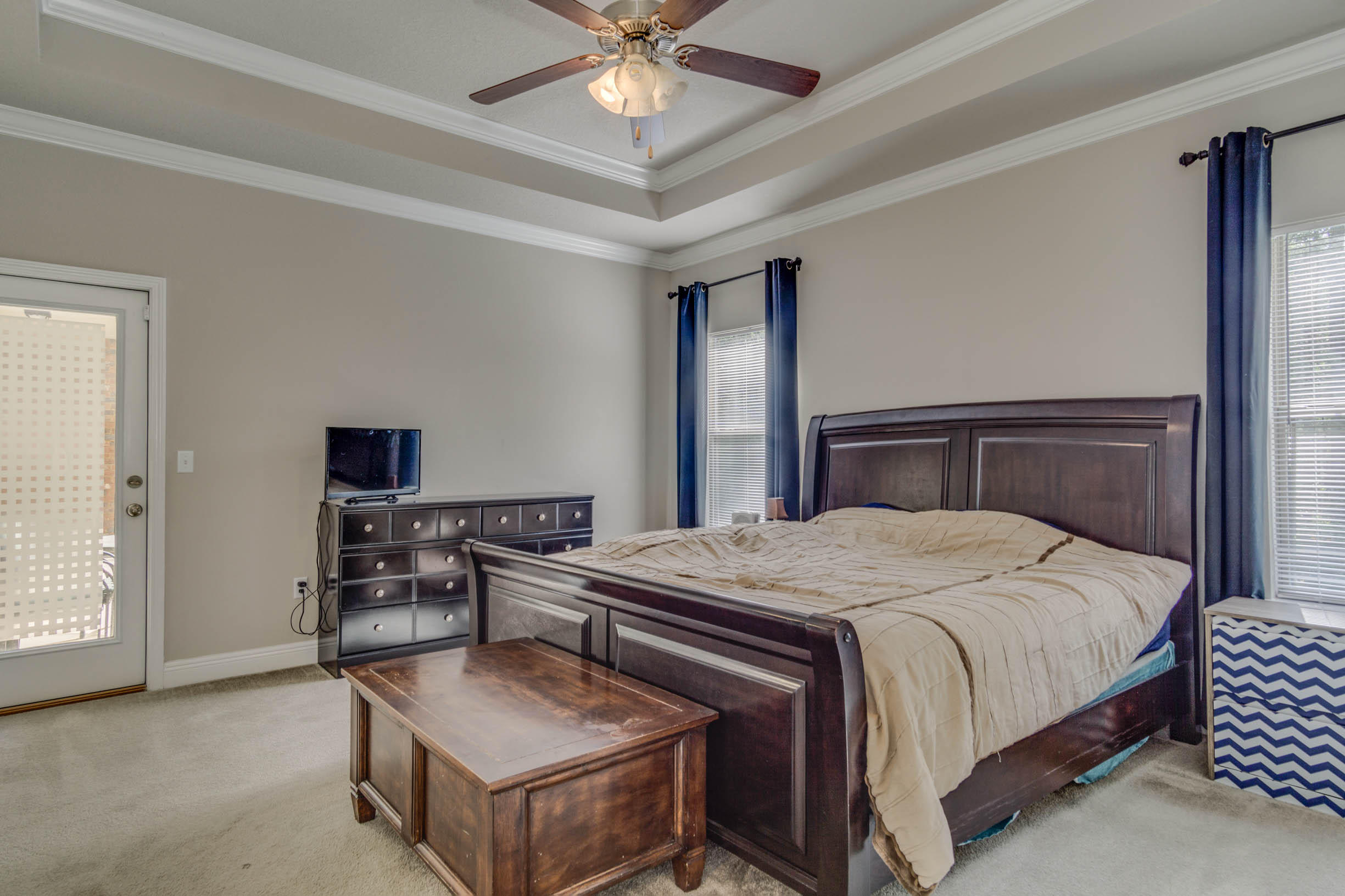 644 Red Fern Road Crestview, FL 32536 - Photo 39 of 46 a bedroom with a bed and a chandelier