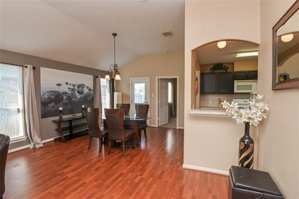 18446 South Wimbledon Drive Katy, TX 77449 - Photo 14 of 24 a view of a dining room with furniture window and wooden floor