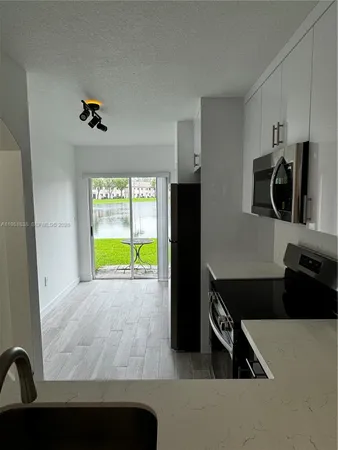 a kitchen with a refrigerator and a sink