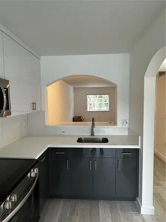a kitchen with a sink and cabinets