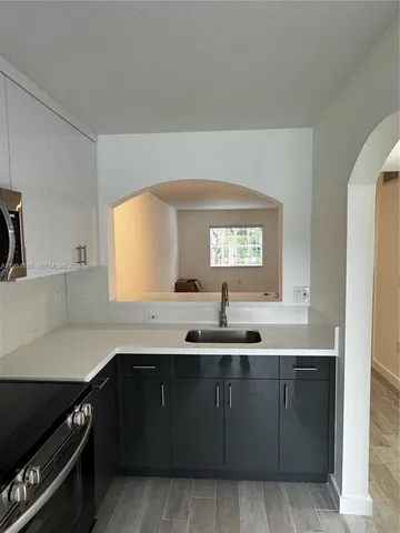 a kitchen with a sink and cabinets