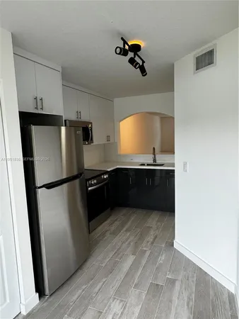 a kitchen with stainless steel appliances a refrigerator and a sink