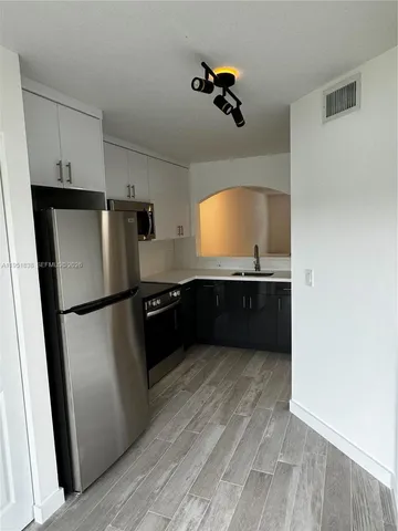 a kitchen with stainless steel appliances a refrigerator and a sink