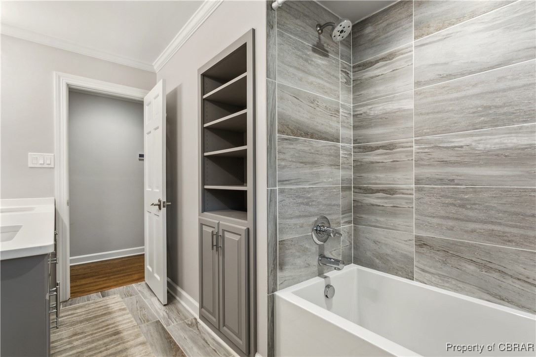 9300 Marlfield Road Gloucester, VA 23061 - Photo 31 of 50 Bathroom with ornamental molding, tiled shower / bath combo, vanity, and hardwood / wood-style flooring