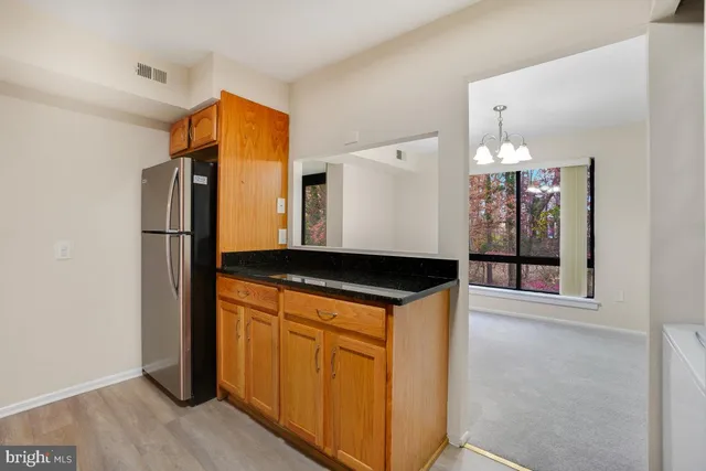 a view of a refrigerator in kitchen and wooden floor