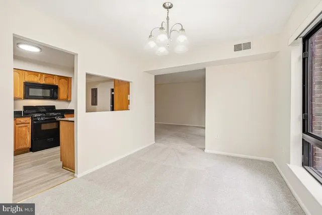 a view of a kitchen with a sink and dishwasher a refrigerator with wooden floor