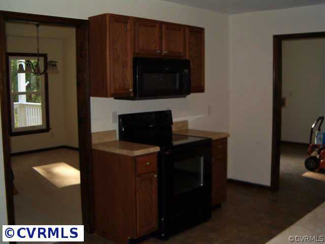 10741 Beaver Bridge Road Chesterfield, VA 23838 - Photo 3 of 7 a kitchen with a stove and a microwave