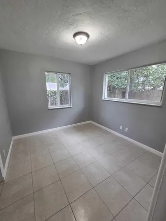 a view of an empty room with windows