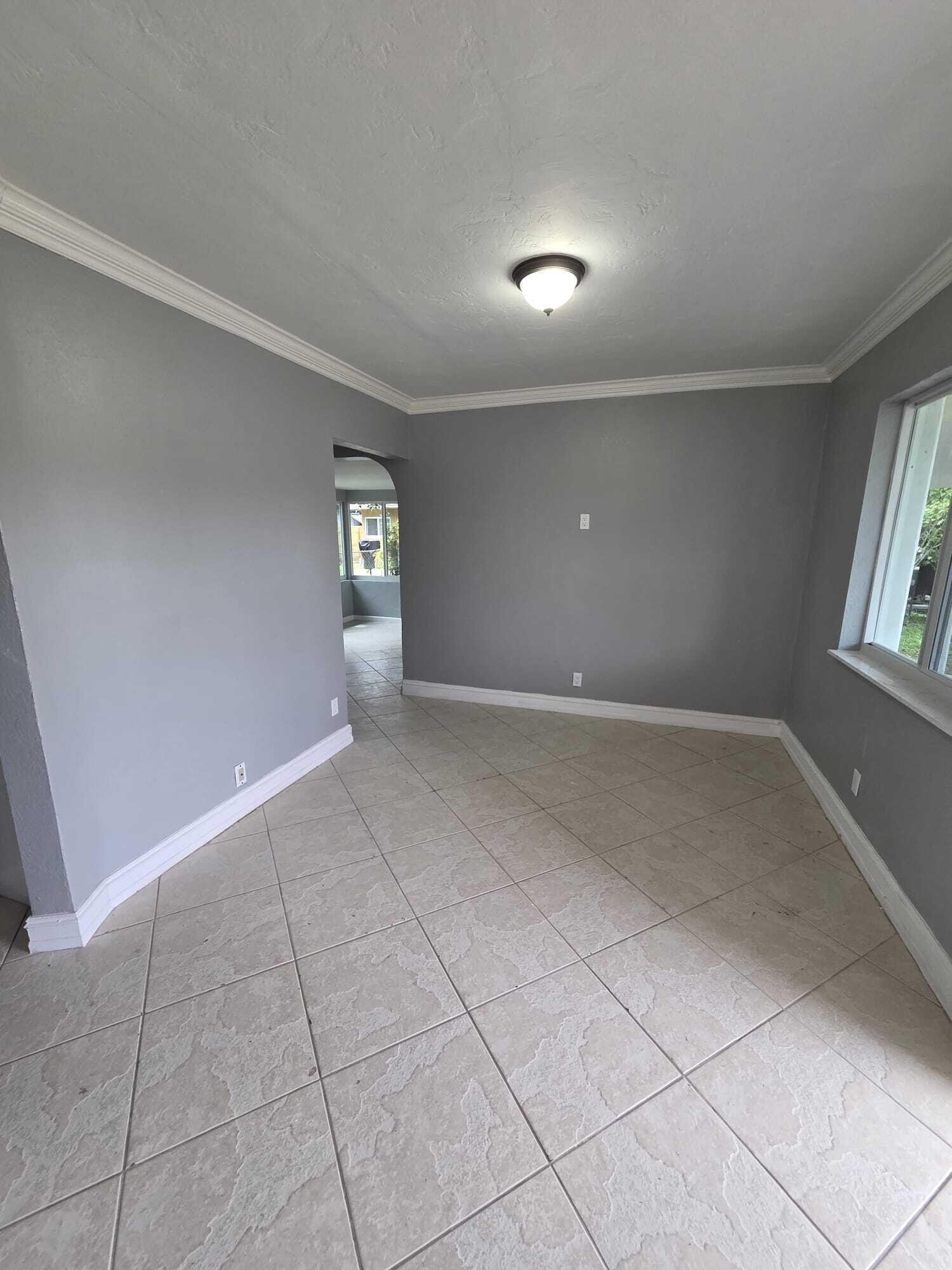 5720 Cleveland Street Hollywood, FL 33021 - Photo 13 of 18 a view of an empty room with windows
