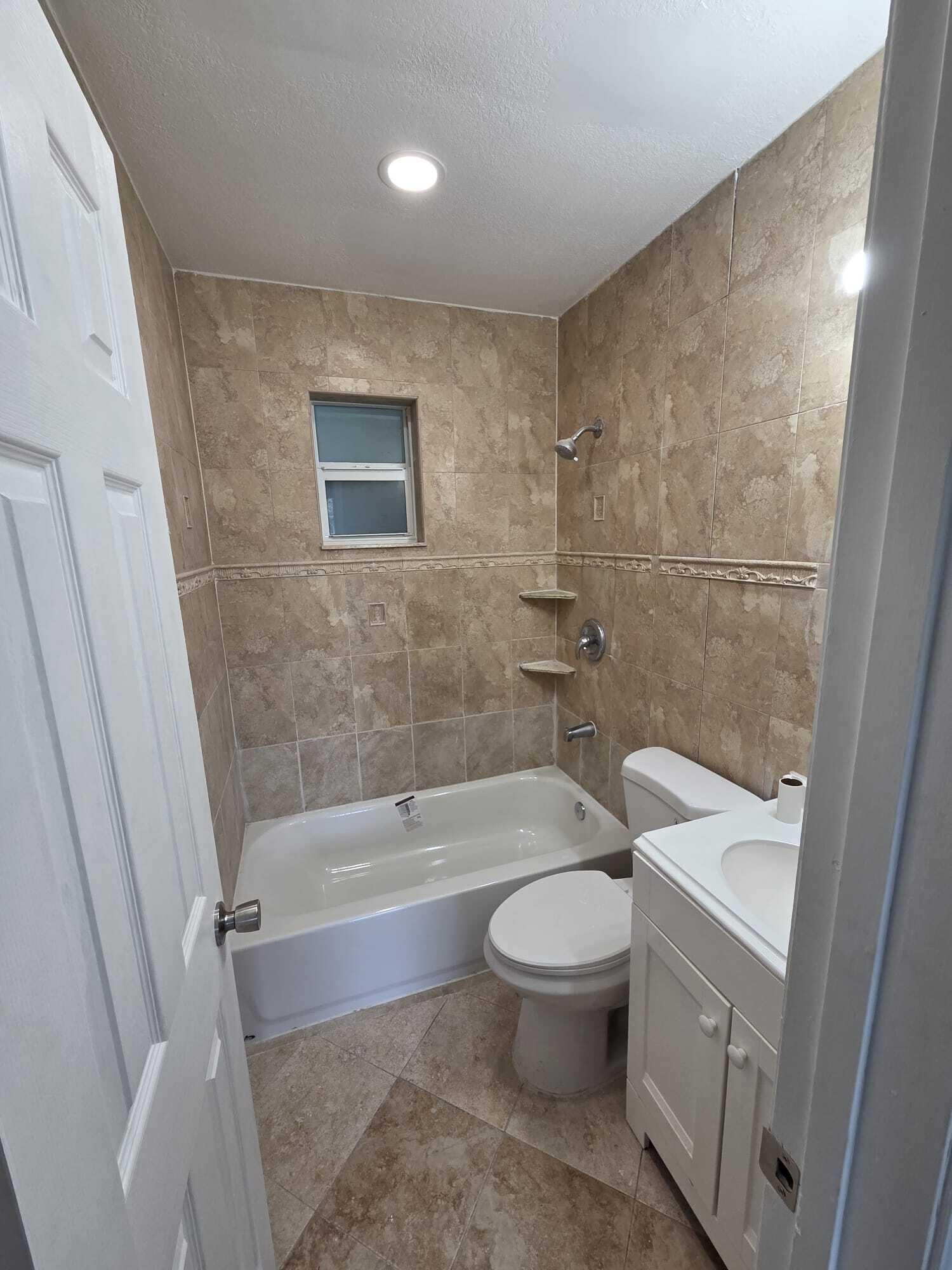 5720 Cleveland Street Hollywood, FL 33021 - Photo 15 of 18 a bathroom with a bathtub toilet and sink