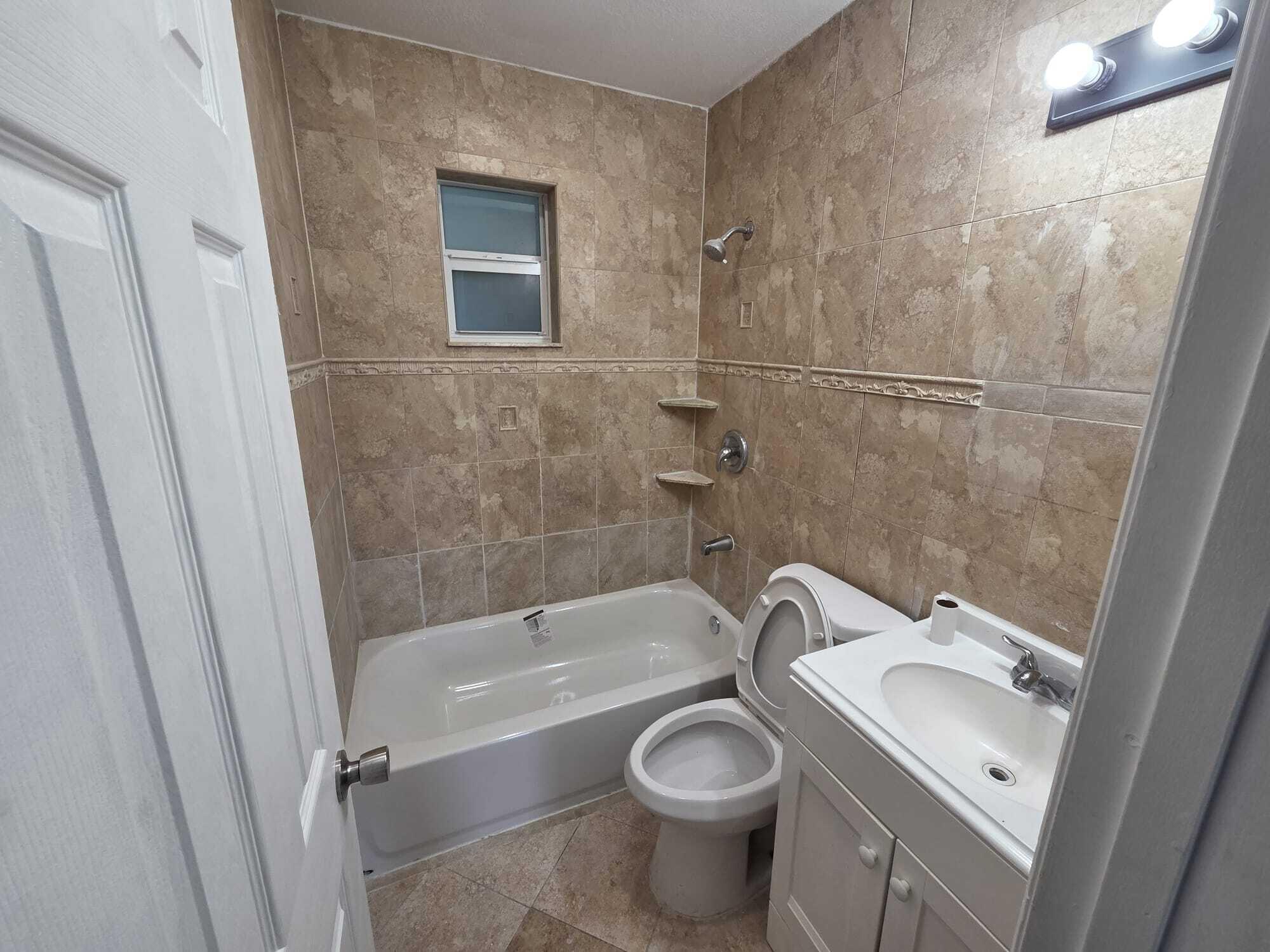 5720 Cleveland Street Hollywood, FL 33021 - Photo 16 of 18 a bath room with a toilet and a tub