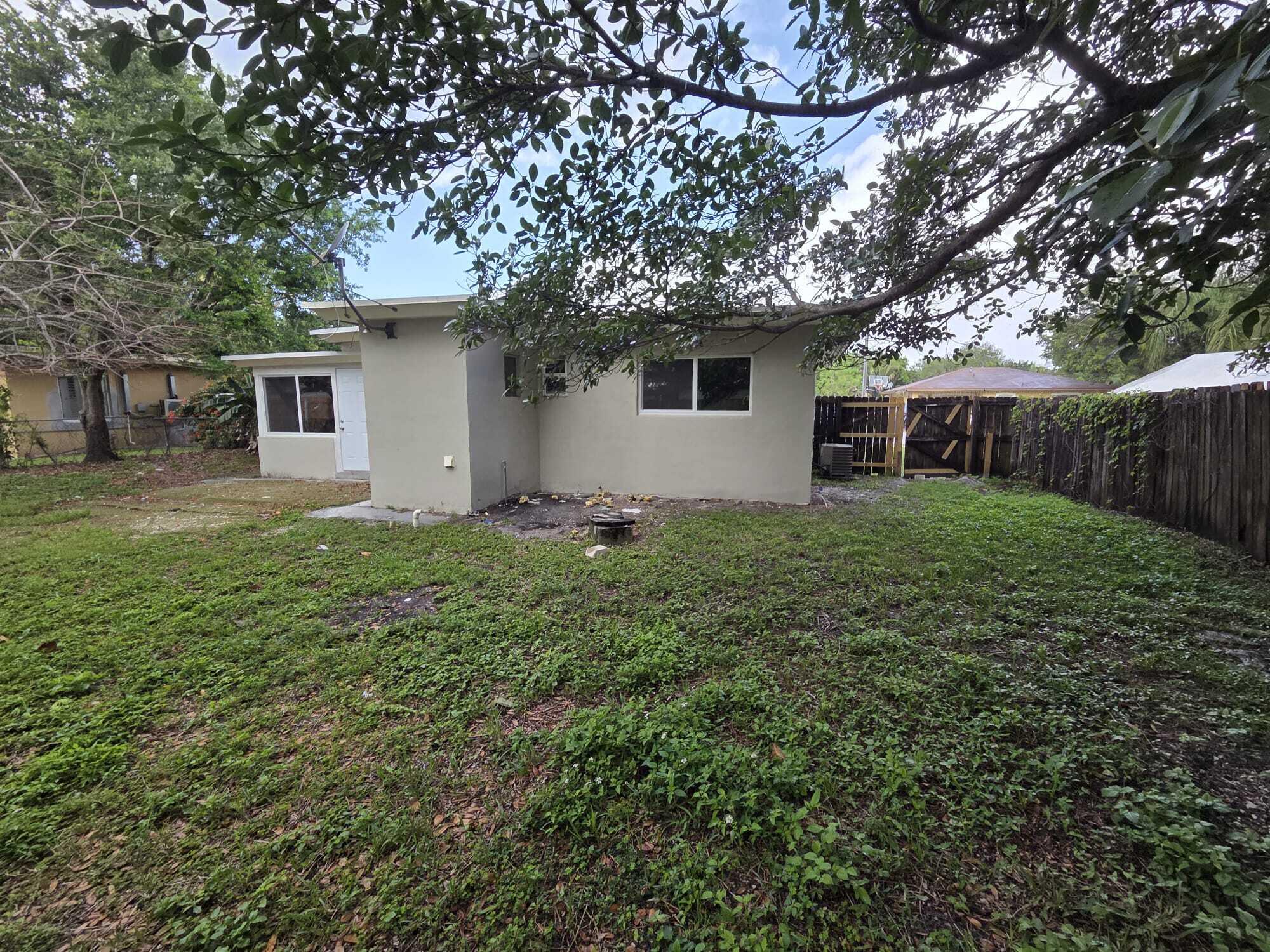 5720 Cleveland Street Hollywood, FL 33021 - Photo 18 of 18 a view of a house with yard and a tree