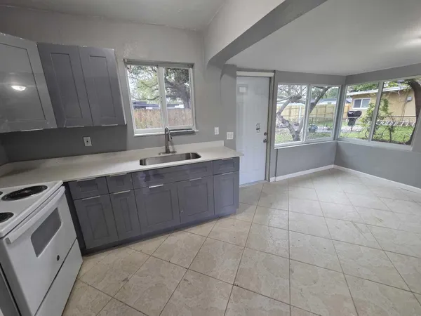 a kitchen with a sink a counter top space and appliances