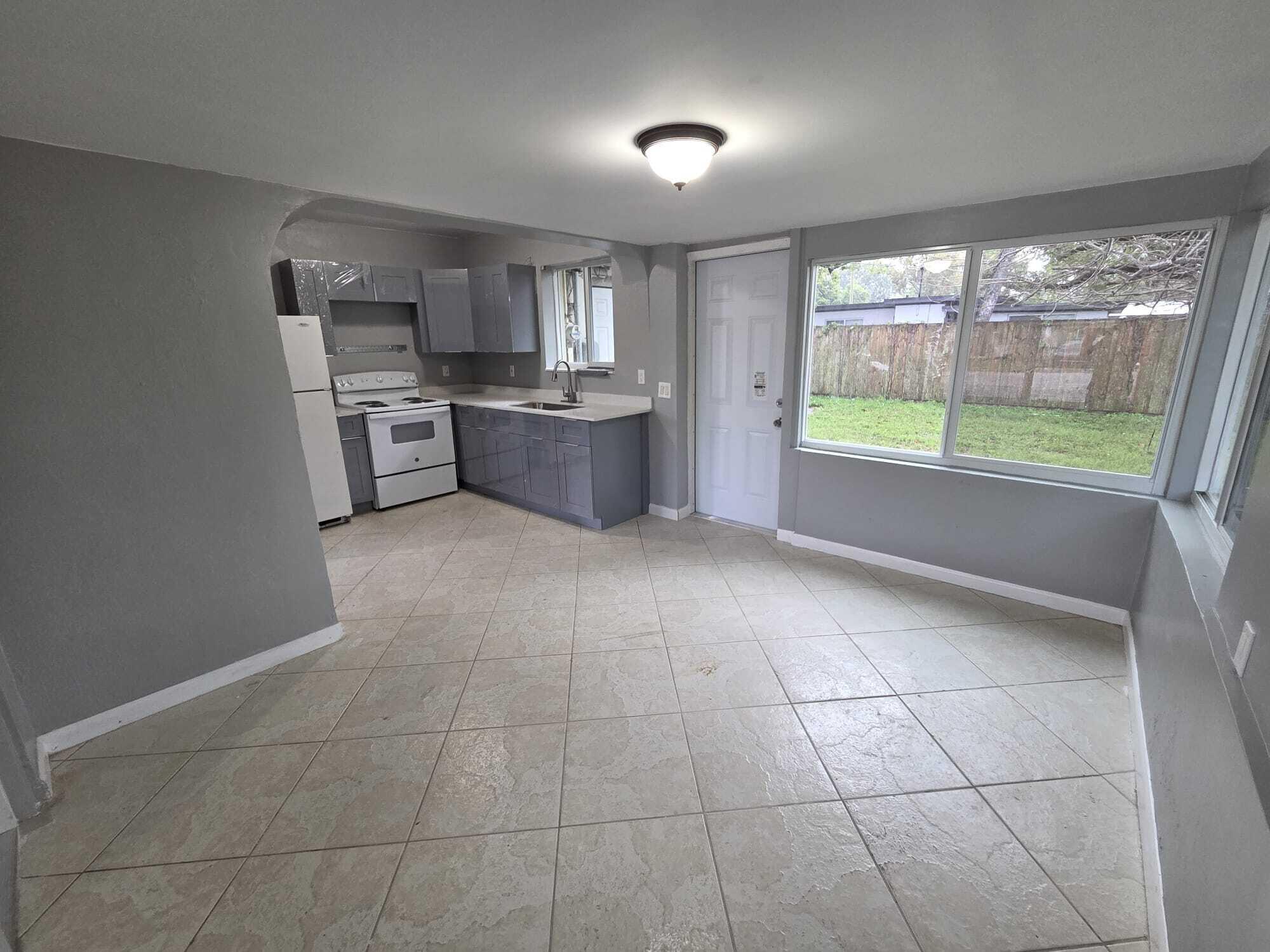 5720 Cleveland Street Hollywood, FL 33021 - Photo 3 of 18 a large white kitchen with a large window
