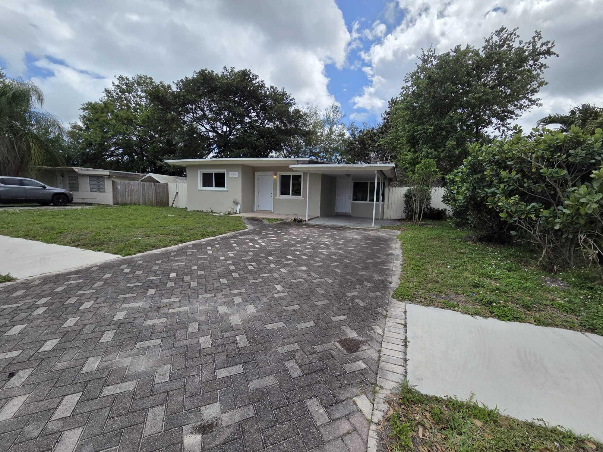 5720 Cleveland Street Hollywood, FL 33021 - Photo 5 of 18 a view of a house with yard and a garden
