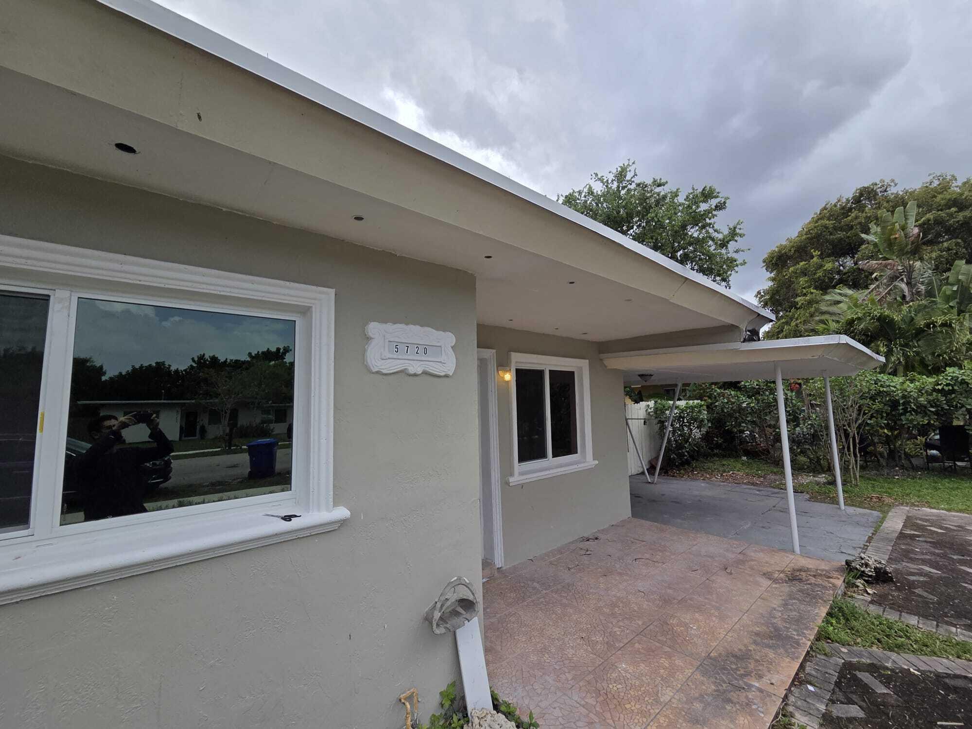 5720 Cleveland Street Hollywood, FL 33021 - Photo 7 of 18 a view of a house with a backyard and porch