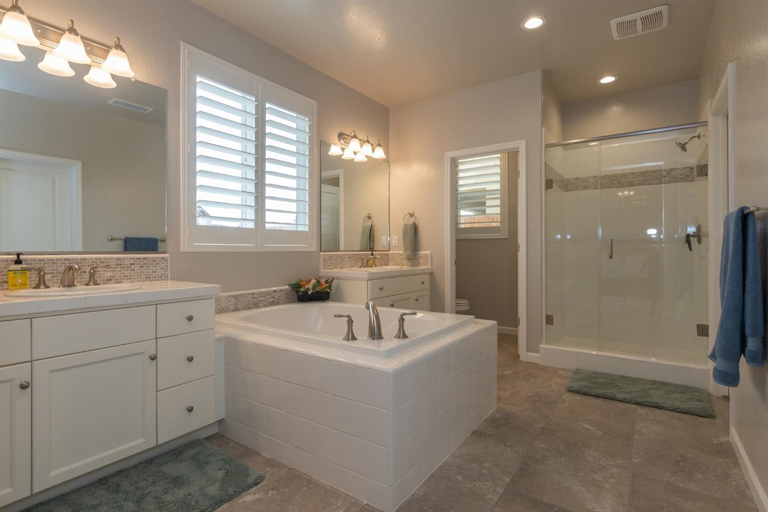 1063 Soledad Avenue Clovis, CA 93619 - Photo 12 of 26 a bathroom with a double vanity sink mirror and shower
