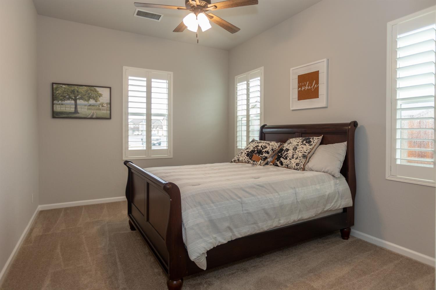 1063 Soledad Avenue Clovis, CA 93619 - Photo 15 of 26 a bedroom with a bed and a chandelier