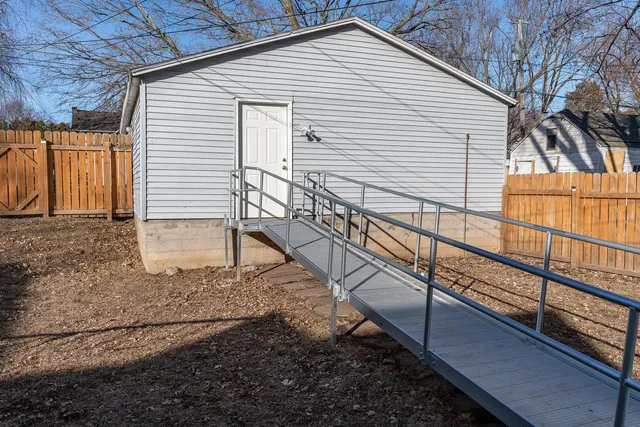 a view of a house with a small deck